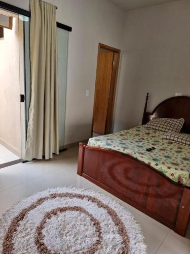 a bedroom with a bed and a rug on the floor at Espaço Run in Bálsamo