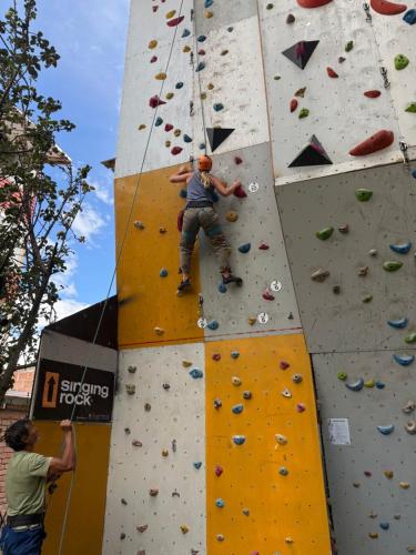 a man is climbing on a climbing wall at Vertigo Climbing Hostel in Urubamba