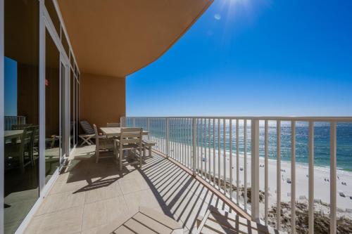 a balcony with a table and chairs and the ocean at Phoenix Gulf Towers 906 condo in Gulf Shores