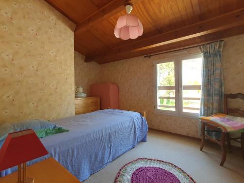 une chambre avec un lit bleu et une fenêtre dans l'établissement Maison agréable entre mer et campagne, proche plage et centre-ville, animaux permis - FR-1-476-98, à Grues