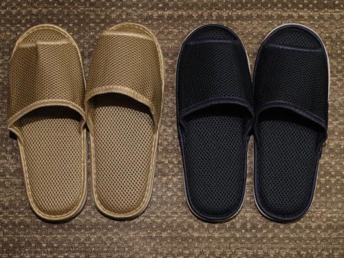 two pairs of shoes sitting next to each other at Dormy Inn Premium Wakayama Natural Hot Spring in Wakayama