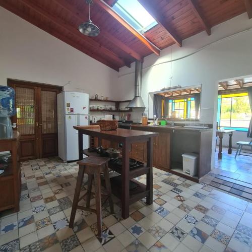 una cucina con un tavolo in legno e un piano di lavoro di Casa de campo boutique a 18 minutos de Merlo a Cortaderas