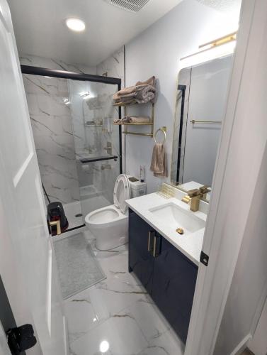 a bathroom with a sink and a toilet and a shower at Chic 2BR Suite with Kitchen, Laundry, Near Elk Island & West Edmonton Mall in Edmonton