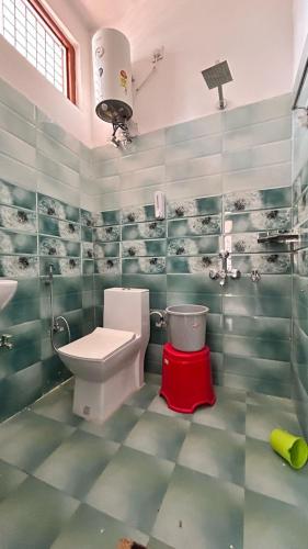 a bathroom with a toilet and a sink at Happy Inn in Faizābād