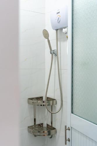 a shower in a bathroom next to a glass door at Vicky's House- Budget Single Room in Nha Trang