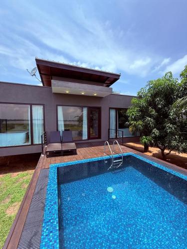 a villa with a swimming pool and a house at Blue Wild - Yala - Plastic Free & Sustainable in Tissamaharama
