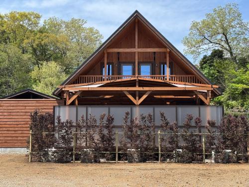 a house with a fence in front of it at P's Wood 伊豆高原 in Ito