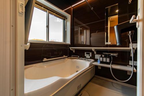 a large bath tub in a bathroom with a window at MIRISE Sky Villa & Sauna in Minakami