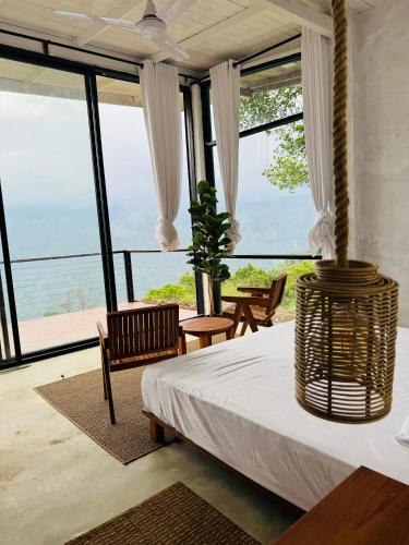 a bedroom with a bed and a view of the ocean at Villa Joy Ella in Ella