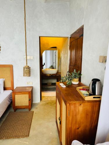 a room with a bedroom with a bed and a sink at Villa Joy Ella in Ella