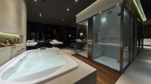 a large bathroom with a tub and a shower at Ville Saint Germain Apart Hotel & Spa in Carilo