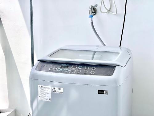a washing machine with a cord hooked up to it at STAR BAY Residence Sihanoukville - 400m to Sokha Beach in Sihanoukville