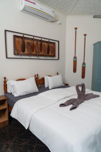 two beds sitting next to each other in a room at Paddle Cult Surf & Yoga in Varkala