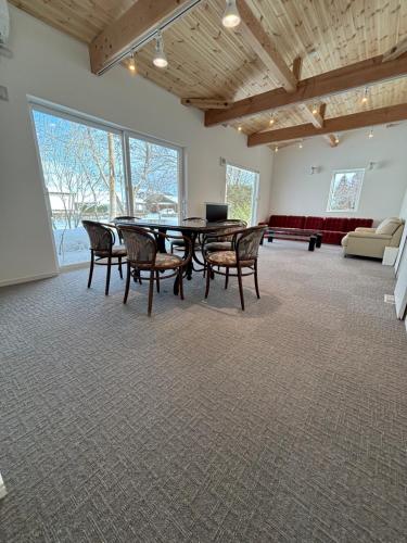 a large room with a table and chairs and a couch at Rental House Towada in Towada