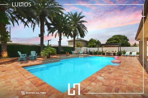 a swimming pool in a yard with palm trees at Oasis with Pool Spa Games 5BR L21 in Miami Gardens