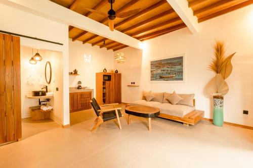 a living room with a couch and a table at Brand-New Loft Balangan Village in Badung