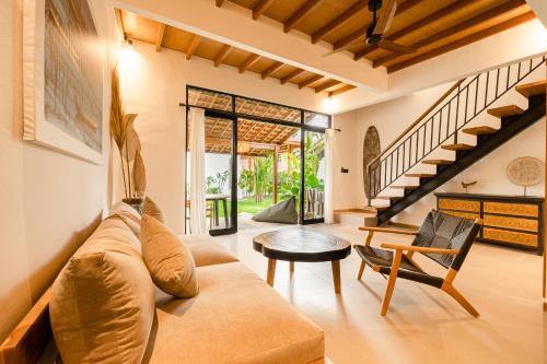a living room with a couch and a table at Brand-New Loft Balangan Village in Badung