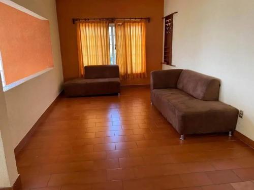a living room with a couch and a chair at Casa Bugambilia in Temixco