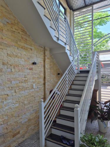 a staircase in a house with a brick wall at Dathao in Thôn Dương Xuân Hạ
