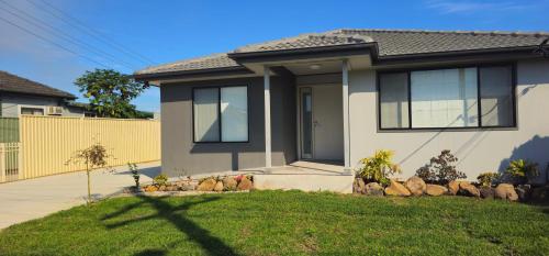 a house with a fence and a yard at Brand new fully accessible 5 bedroom house in Fairfield