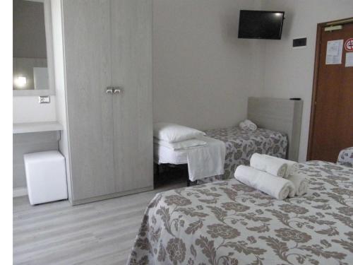 a room with two beds with towels on them at Hotel Stefan Room & Breakfast in Gatteo a Mare