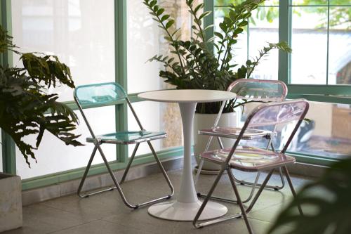 two chairs and a table in front of a window at Jim’s House in Da Nang