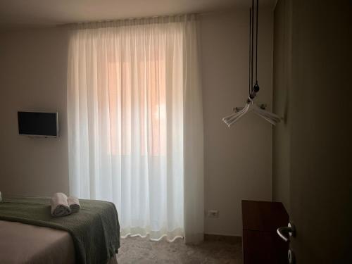 a bedroom with a bed and a large window at Apartment Nicole in Menaggio