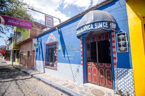 a blue and yellow building on the side of a street at Hotel Casa Blanca in Ajijic