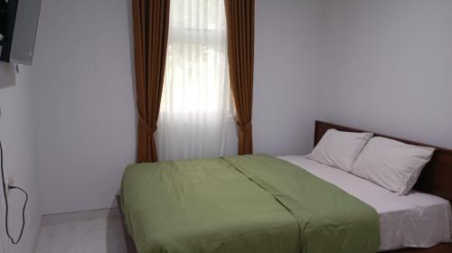 Ένα ή περισσότερα κρεβάτια σε δωμάτιο στο villa cattleya inn