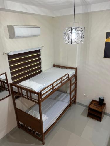 a bunk bed in a room with a pendant light at Antonia Transient House in Calingcuan