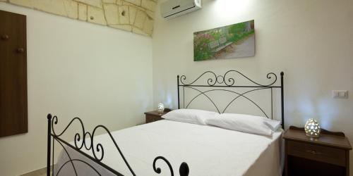 Säng eller sängar i ett rum på Masseria Bosco Mazza