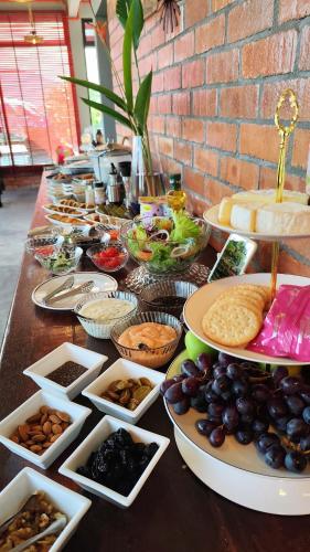 a long table with plates of food on it at The Bukit Resort Langkawi in Kampung Padang Masirat