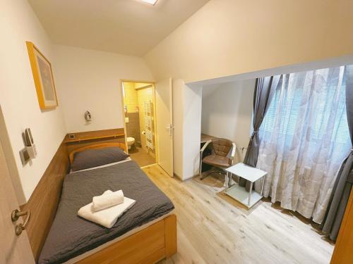 a small bedroom with a bed and a window at Ubytování v Brně - Schodová in Brno