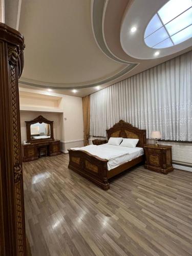 a large bedroom with a bed and a mirror at MIMFRI PREMIUM guest house, hotel in Tashkent