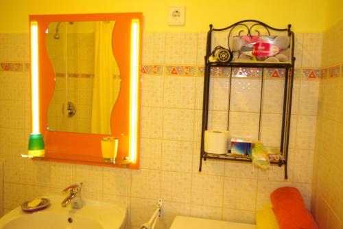 a bathroom with a sink and a mirror at Bors Apartman Szeged in Szeged