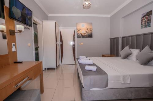 Postel nebo postele na pokoji v ubytování Infinity Hotel