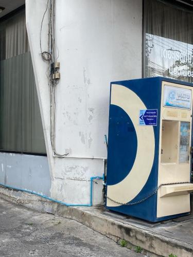 a pepsi machine sitting on the side of a building at รัตนากร แมนชั่น in Bang Su