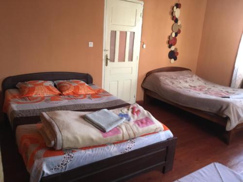 a bedroom with two beds and a door at Antsaly in Antananarivo