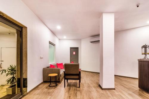 a living room with a couch and chairs at Hotel O Akash Ganga Park Circus in Ballygunge