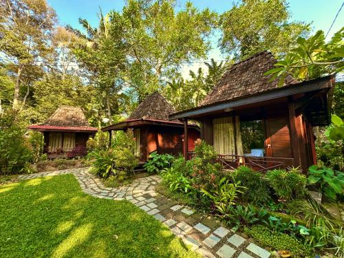 a house with a pathway leading to it at Puunee Wild River Villa's Borobudur in Borobudur