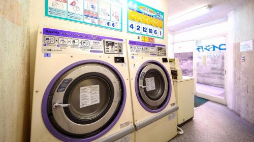 a washer and dryer in a laundry room at New Gloria Oita Hotel in Oita