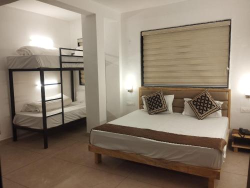 a bedroom with a bed and a bunk bed at LA Riqueza Koala Inn Mcleo Ganj # Close to Mall Road # Rooftop Restaurant with Mountain View # In-house Parking in McLeod Ganj