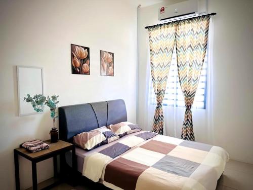 a bedroom with a bed and a window at Maison Pekan in Pekan