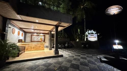 a building with a pavilion in a courtyard at night at Villa Karma Loka in Sidemen