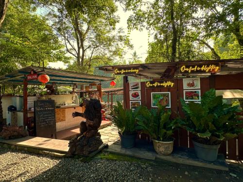 a food stand with a statue in front of it at Puunee Wild River Villa's Borobudur in Borobudur