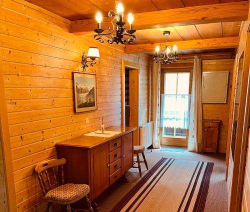 a bathroom with a sink and a wooden wall at Ferienhaus Unterkircher-Wallner in Heiligenblut