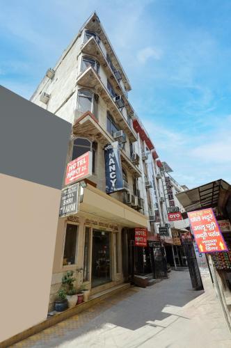 a building on a street with signs on it at Hotel Nancy Dx Near New Delhi Railway Station in New Delhi