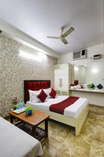 a bedroom with a large bed and a table at Hotel Nancy Dx Near New Delhi Railway Station in New Delhi