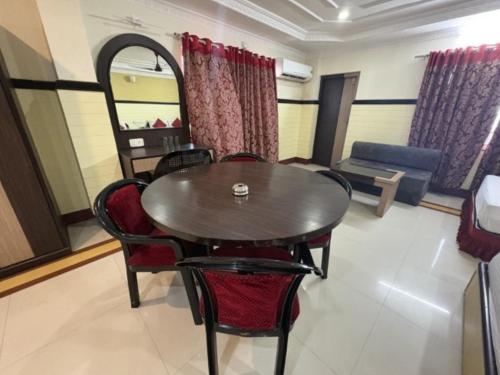 a dining room with a table and chairs at Hotel Inn New Digha With Classic Swimming Pool in Digha