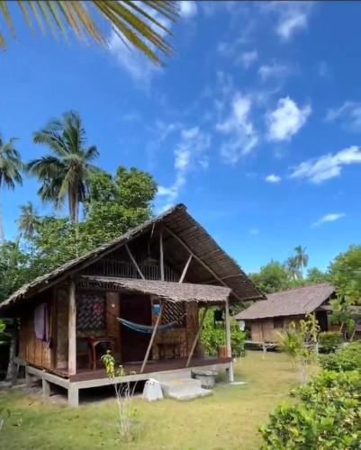 a small house with a thatched roof at Mutiara Beach Resort in Berakit